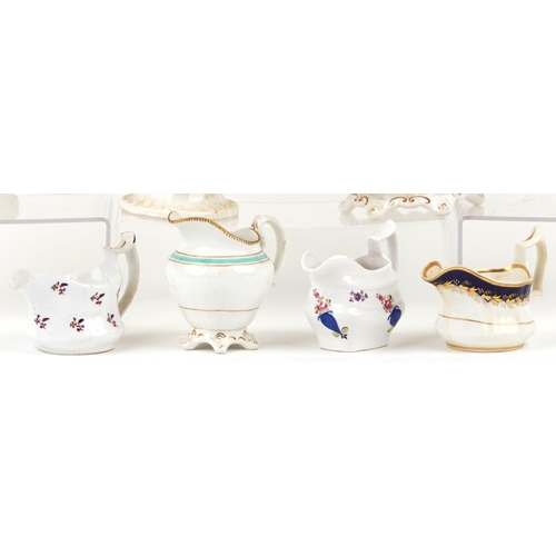 430 - 19th century English porcelain teapots and milk jugs, each with hand painted decoration, the largest... 