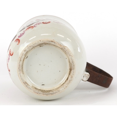 353 - A Chinese export porcelain tankard with metal handle hand painted with a European scene, 16cm high.