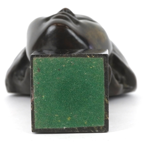 227 - A patinated bronze portrait of an Asian female raised on a marble base, 17cm high.
