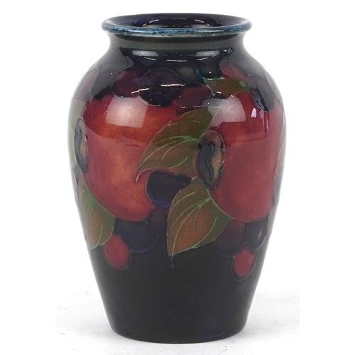 181 - A William Moorcroft Pomegranate pattern pottery vase, 9cm high.