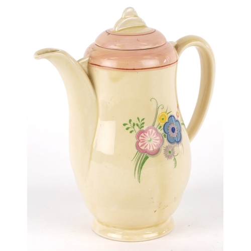 321 - A Clarice Cliff Wilkinson coffee pot hand painted and transfer printed with flowers, 17cm high.