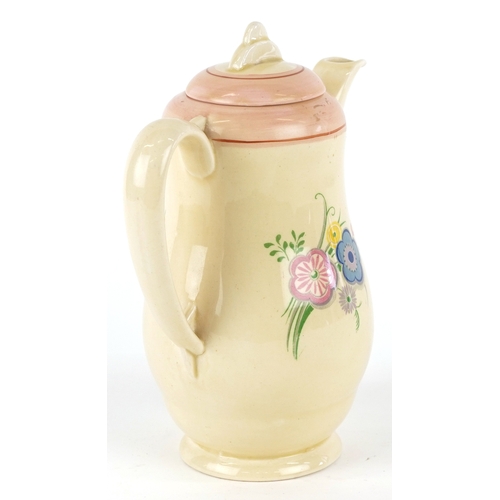 321 - A Clarice Cliff Wilkinson coffee pot hand painted and transfer printed with flowers, 17cm high.