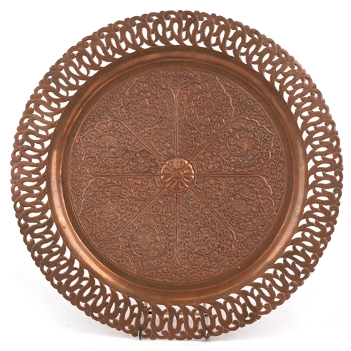 1893 - A Middle Eastern copper tray with repousse floral decoration and pierced rim, 38cm in diameter.
