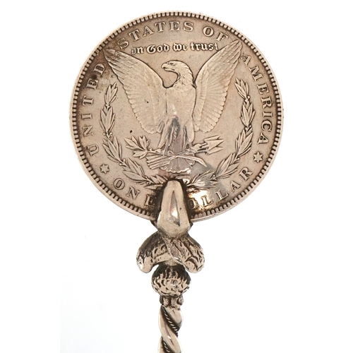 3664 - A USA 1899 silver Morgan dollar spoon, 18cm in length, 51.4g.