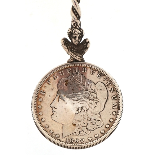 3664 - A USA 1899 silver Morgan dollar spoon, 18cm in length, 51.4g.