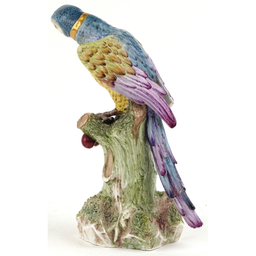 37 - An early 20th century Sampson porcelain parrot perched on a tree stump, 40cm high.