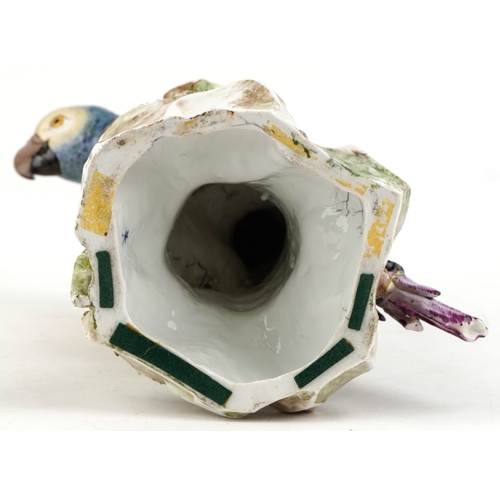 37 - An early 20th century Sampson porcelain parrot perched on a tree stump, 40cm high.