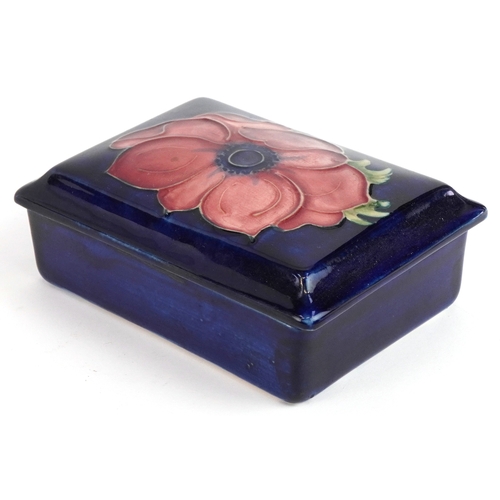 189 - A Moorcroft pottery box and cover hand painted in the Anemone pattern, 12cm wide.