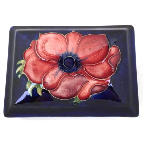 189 - A Moorcroft pottery box and cover hand painted in the Anemone pattern, 12cm wide.