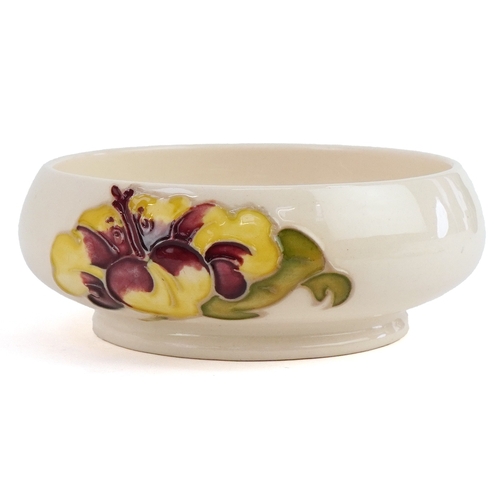 187 - A white Moorcroft pottery bowl hand painted in the Hibiscus pattern, 12cm in diameter.