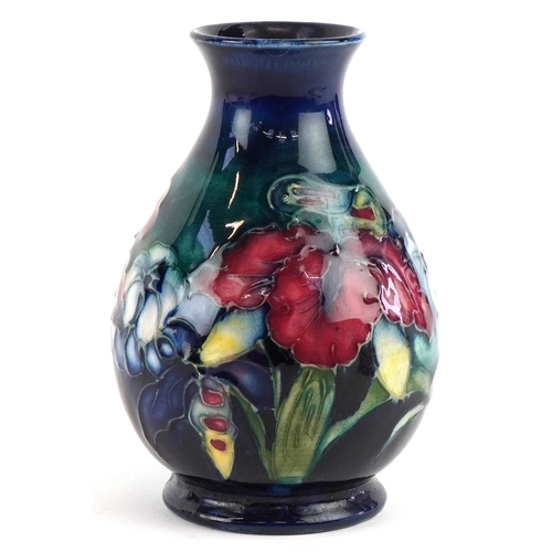 178 - A Moorcroft pottery baluster vase hand painted in the Orchid pattern, 12cm high.