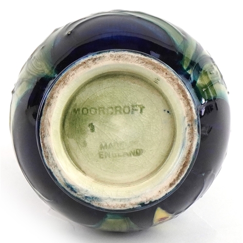 178 - A Moorcroft pottery baluster vase hand painted in the Orchid pattern, 12cm high.