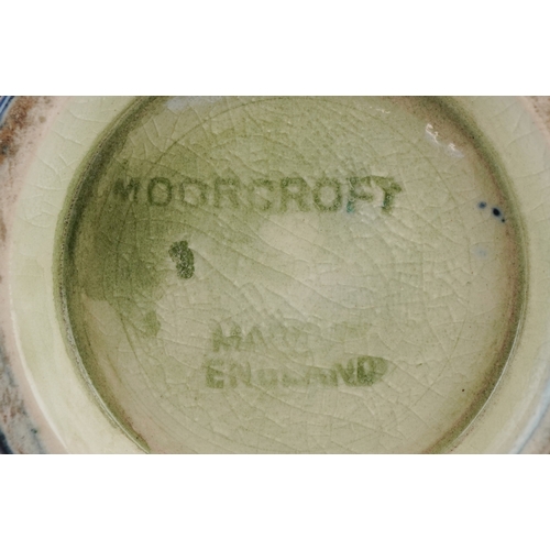 178 - A Moorcroft pottery baluster vase hand painted in the Orchid pattern, 12cm high.