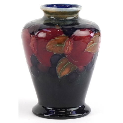 184 - A Moorcroft pottery vase hand painted in the Pomegranate pattern, 9cm high.