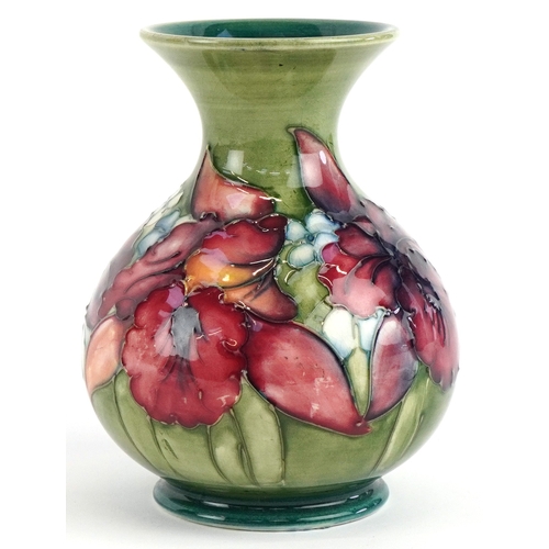 183 - A Moorcroft pottery baluster vase hand painted in the Orchid pattern 13cm high.