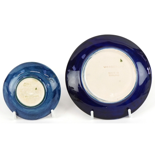 190 - Two Moorcroft pottery dishes, one hand painted in the Hibiscus and Magnolia patterns, the largest 11... 