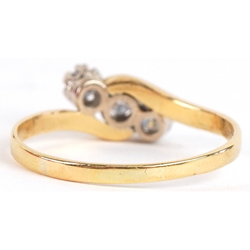 3014 - An 18ct gold diamond three stone crossover ring, total diamond weight approximately 0.40 carat, size... 