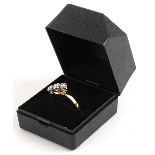 3014 - An 18ct gold diamond three stone crossover ring, total diamond weight approximately 0.40 carat, size... 