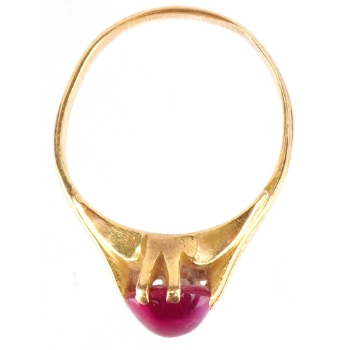 3018 - An unmarked high carat gold cabochon ruby ring, the ruby approximately 9.40mm x 6.0mm x 3.60mm deep,... 