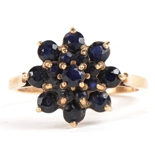 3285 - A 9ct gold sapphire and blue spinel three tier flower head ring, size P, 3.1g.
