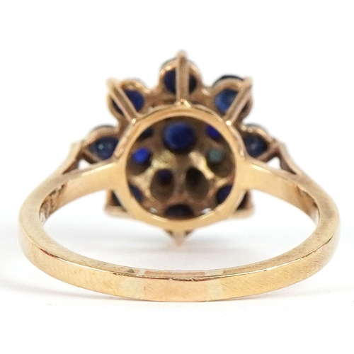 3285 - A 9ct gold sapphire and blue spinel three tier flower head ring, size P, 3.1g.