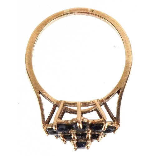 3285 - A 9ct gold sapphire and blue spinel three tier flower head ring, size P, 3.1g.