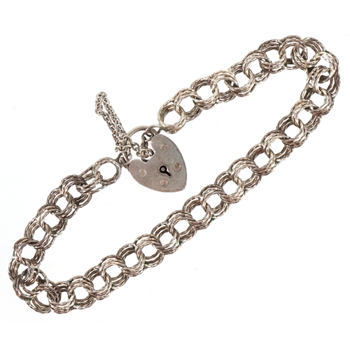 3257 - A silver multi link charm bracelet with love heart shaped padlock clasp, 18cm in length, 11.0g.