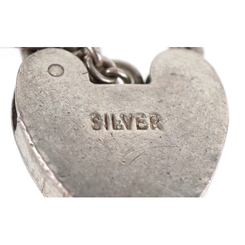 3257 - A silver multi link charm bracelet with love heart shaped padlock clasp, 18cm in length, 11.0g.