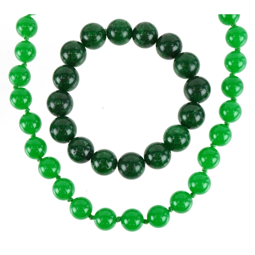 3397 - A Chinese green stone bead necklace and bracelet, both test as jade, the necklace 44cm in length, to... 