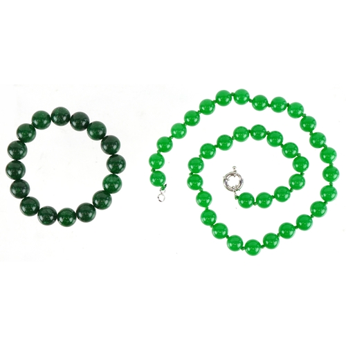 3397 - A Chinese green stone bead necklace and bracelet, both test as jade, the necklace 44cm in length, to... 