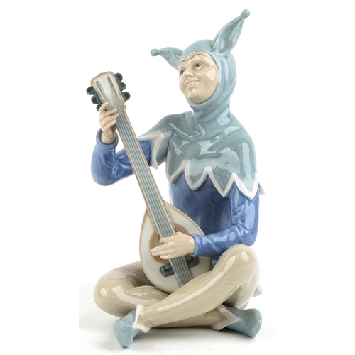 623 - A large Nao porcelain figure of a jester playing a lute, 34cm high.