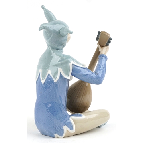 623 - A large Nao porcelain figure of a jester playing a lute, 34cm high.