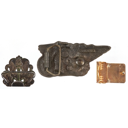 1843 - Three vintage belt buckles including 1986 motorcycle buckle and a white metal wings and torch flame ... 