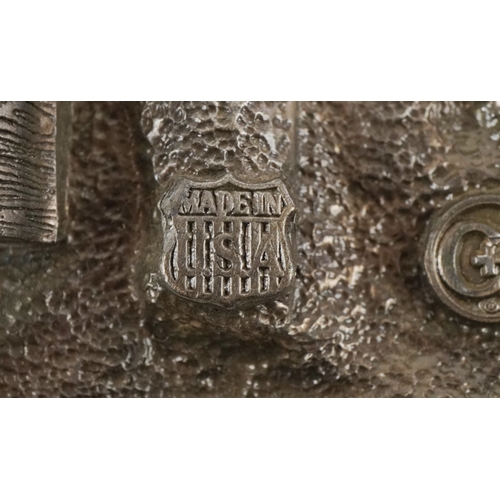 1843 - Three vintage belt buckles including 1986 motorcycle buckle and a white metal wings and torch flame ... 