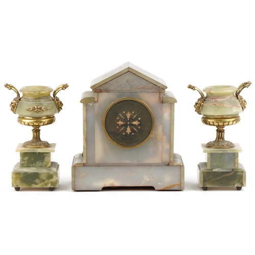 125 - An onyx and brass three piece clock garniture, the clock having an enamelled dial with Arabic numera... 