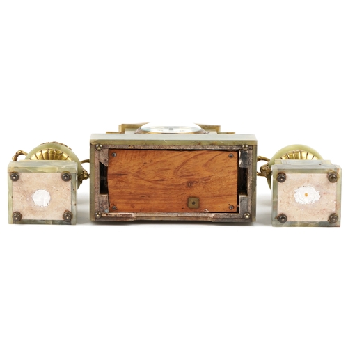 125 - An onyx and brass three piece clock garniture, the clock having an enamelled dial with Arabic numera... 
