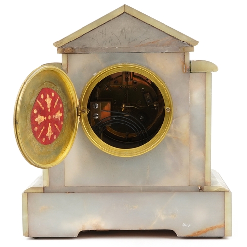 125 - An onyx and brass three piece clock garniture, the clock having an enamelled dial with Arabic numera... 