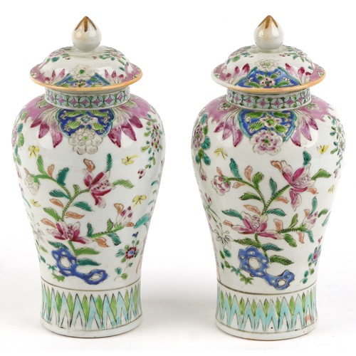 91 - A pair of Chinese famille rose porcelain baluster vases and covers, each with hand painted decoratio... 