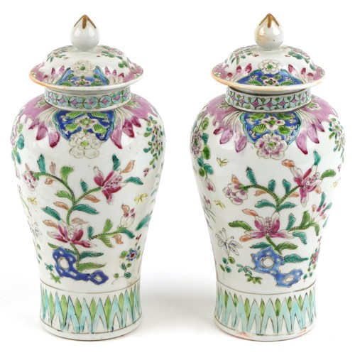 91 - A pair of Chinese famille rose porcelain baluster vases and covers, each with hand painted decoratio... 