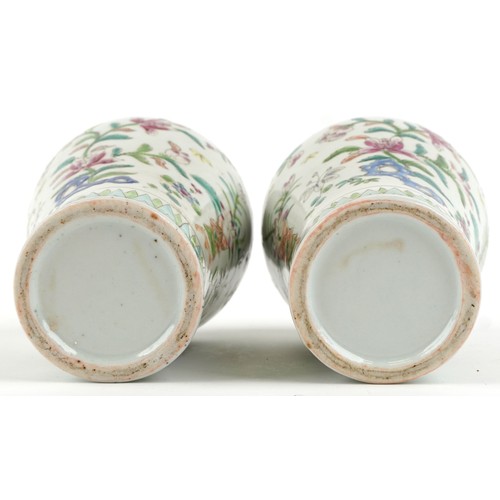 91 - A pair of Chinese famille rose porcelain baluster vases and covers, each with hand painted decoratio... 