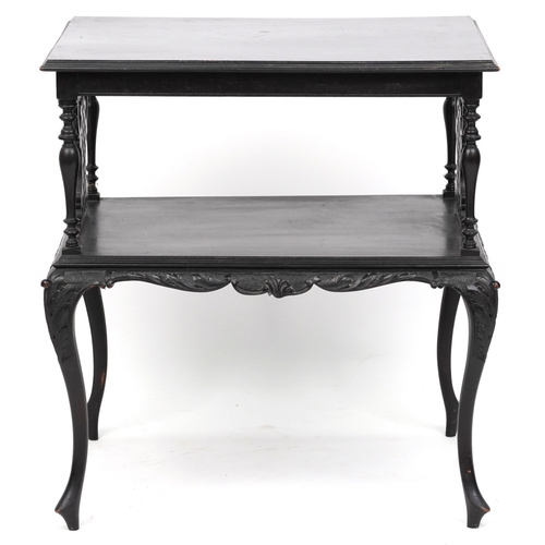 2072 - An early 20th century ebonised two tier side table with carved decoration, raised on cabriole legs, ... 