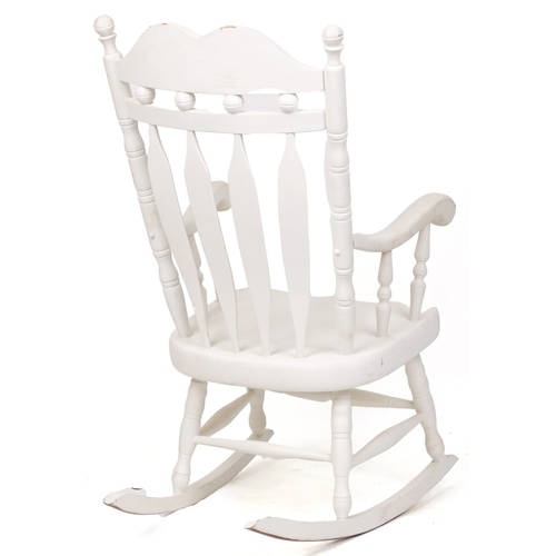 2085 - A 20th century white painted rocking chair on turned supports, 116cm H x 65cm W x 77cm D.