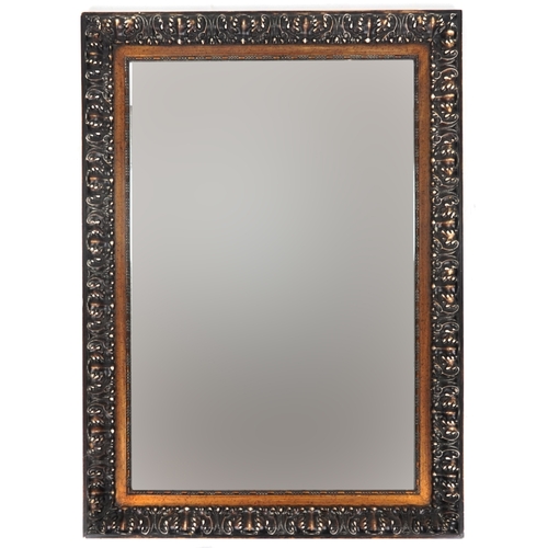 2162 - A late 20th century rectangular mirror with scrolling moulded frame, 110cm x 80cm.