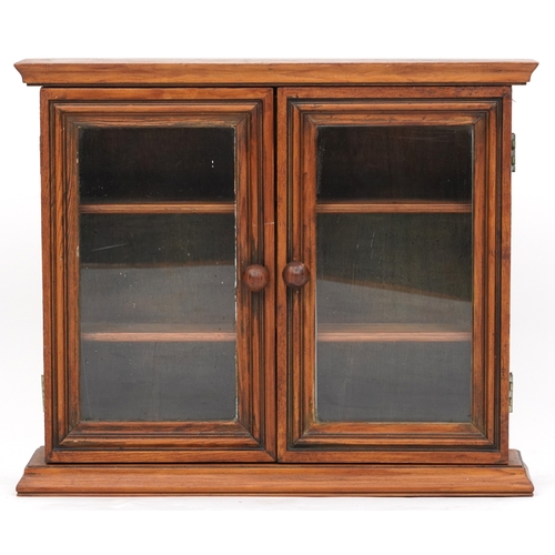 2067 - An early 20th century beech hanging wall cabinet fitted with a pair of glazed doors, 44cm H x 52cm W... 