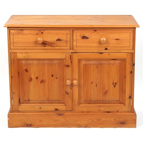 2140 - A late 20th century pine side cabinet fitted with two drawers and cupboards, on a plinth base, 81cm ... 