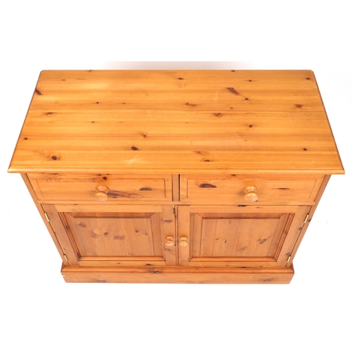 2140 - A late 20th century pine side cabinet fitted with two drawers and cupboards, on a plinth base, 81cm ... 