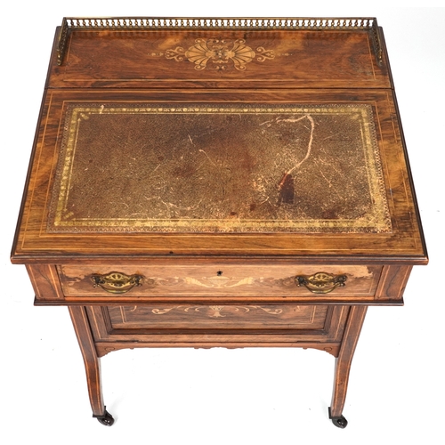 2104 - A late Victorian rosewood desk with inlaid decoration, the gilt metal gallery back above a drawer, o... 
