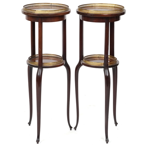 2068 - A pair of early 20th century mahogany jardinière stands, each with brass galleries, raised on tripod... 