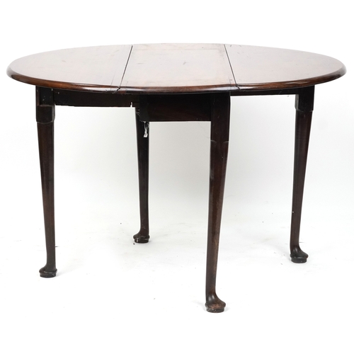 2040 - A late George III mahogany drop flap dining table raised on turned tapering legs and pad feet, 70cm ... 
