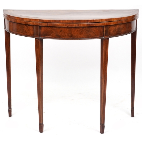 2041 - A late George III mahogany demi lune fold over card table raised on square tapering legs, 73cm H x 9... 